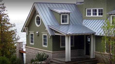 metal roof on green sided craftsman house|house with green roof.